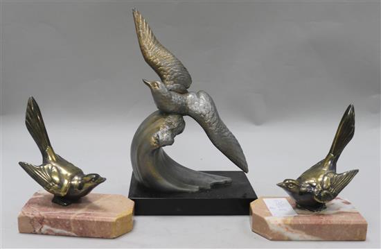 A pair of bird bookends and a bird ornament